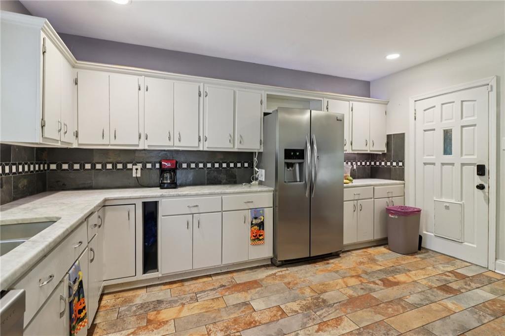 2267 Melante Drive Northeast Atlanta, GA 30324 - Photo 12 of 39 a kitchen with stainless steel appliances granite countertop a refrigerator sink and cabinets