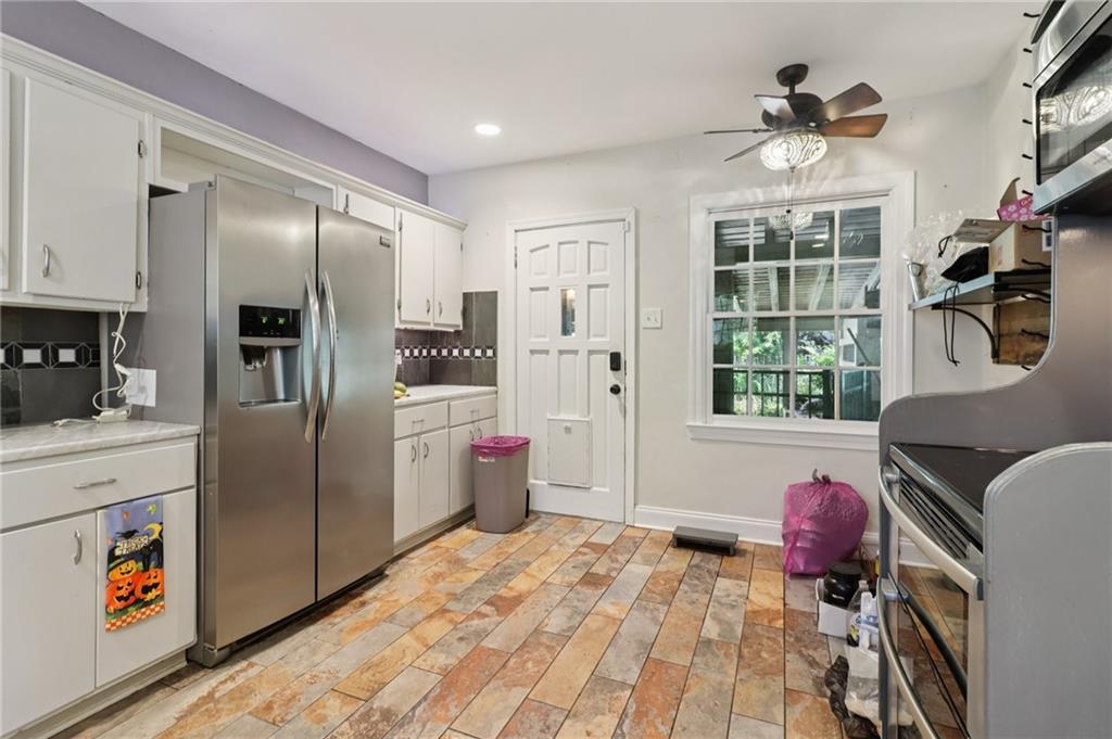 2267 Melante Drive Northeast Atlanta, GA 30324 - Photo 13 of 39 a kitchen with stainless steel appliances granite countertop a refrigerator a oven a sink with island and windows