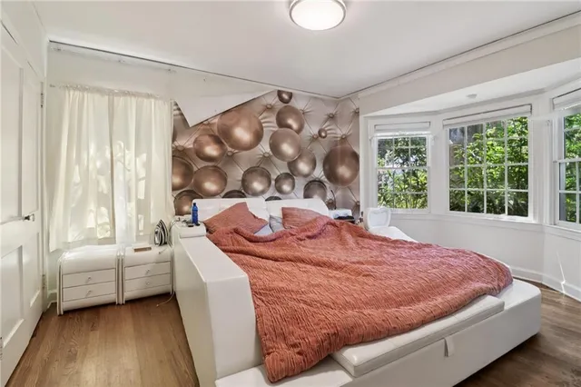 a bed sitting in a bedroom next to a window