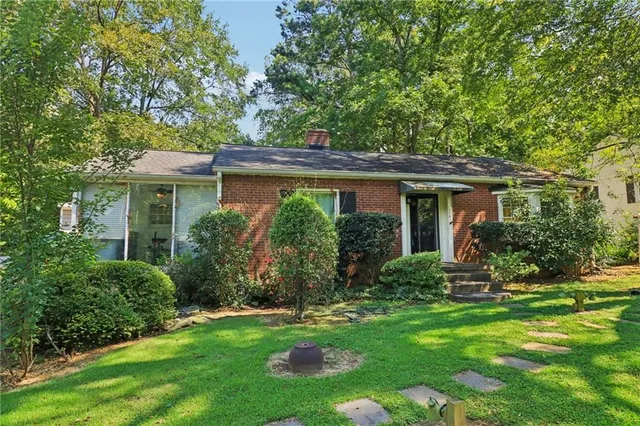 a front view of house with a garden