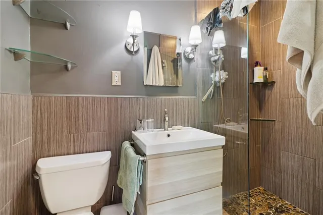 a bathroom with a sink a toilet and shower