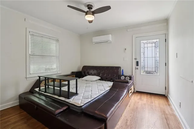 a living room with a bed furniture and a window