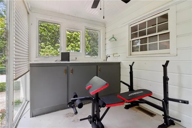 a view of a workspace with furniture and a window