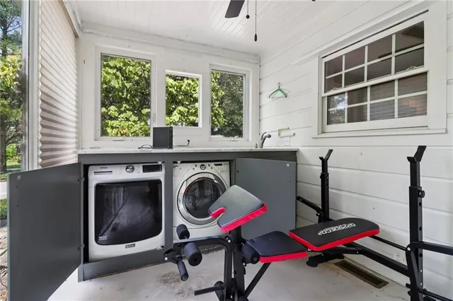 a utility room with dryer washer and a window