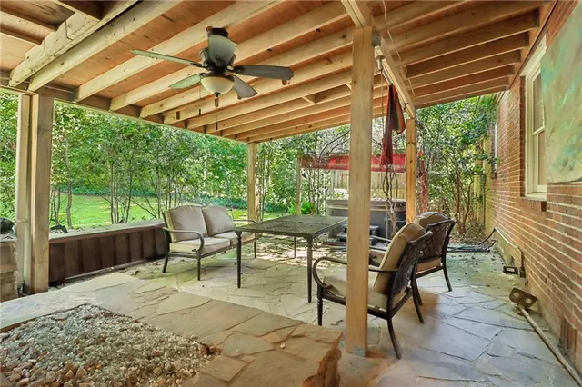 a view of a patio with a table chairs and a backyard