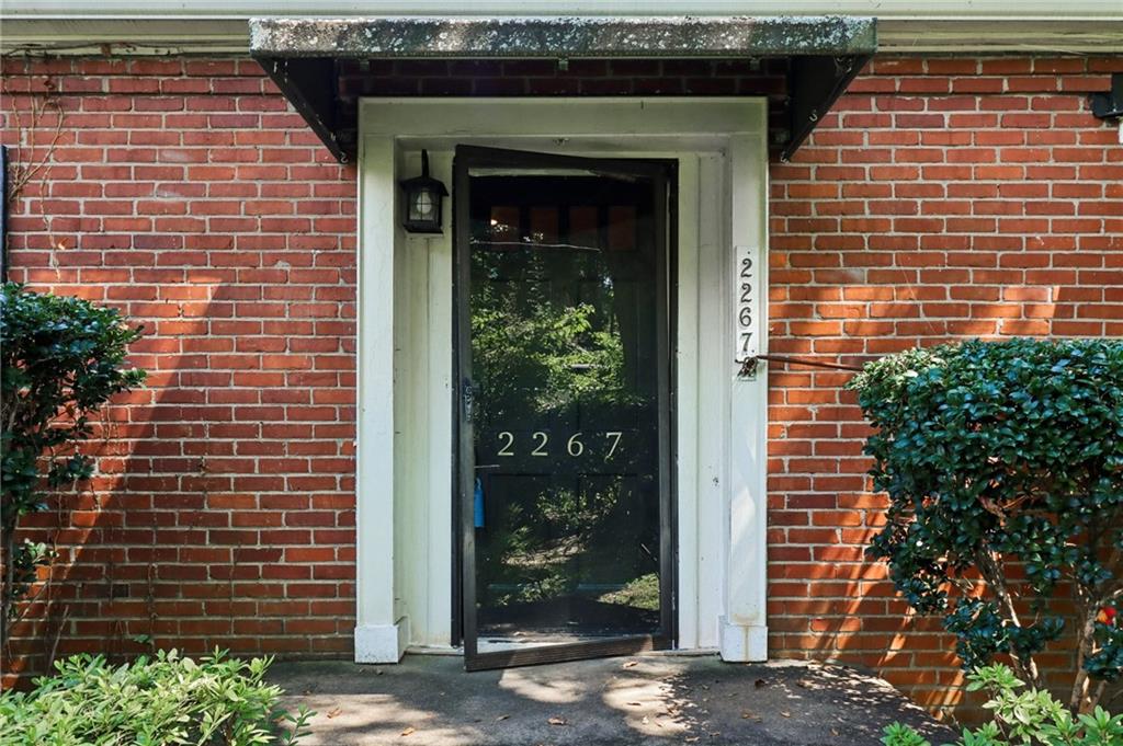 2267 Melante Drive Northeast Atlanta, GA 30324 - Photo 4 of 39 a front view of a house with a garden