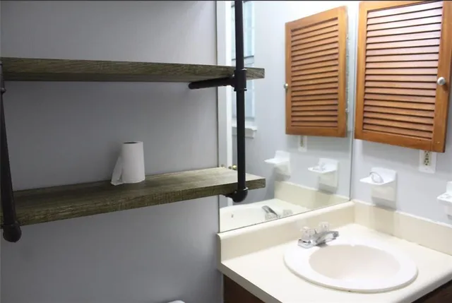 a bathroom with a sink and a mirror