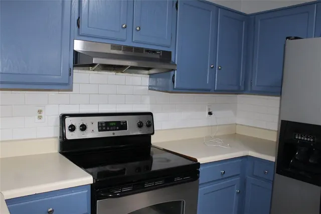 a kitchen with a stove and a refrigerator