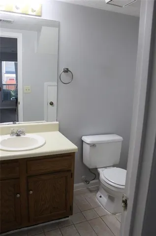 a bathroom with a sink a toilet a mirror and vanity