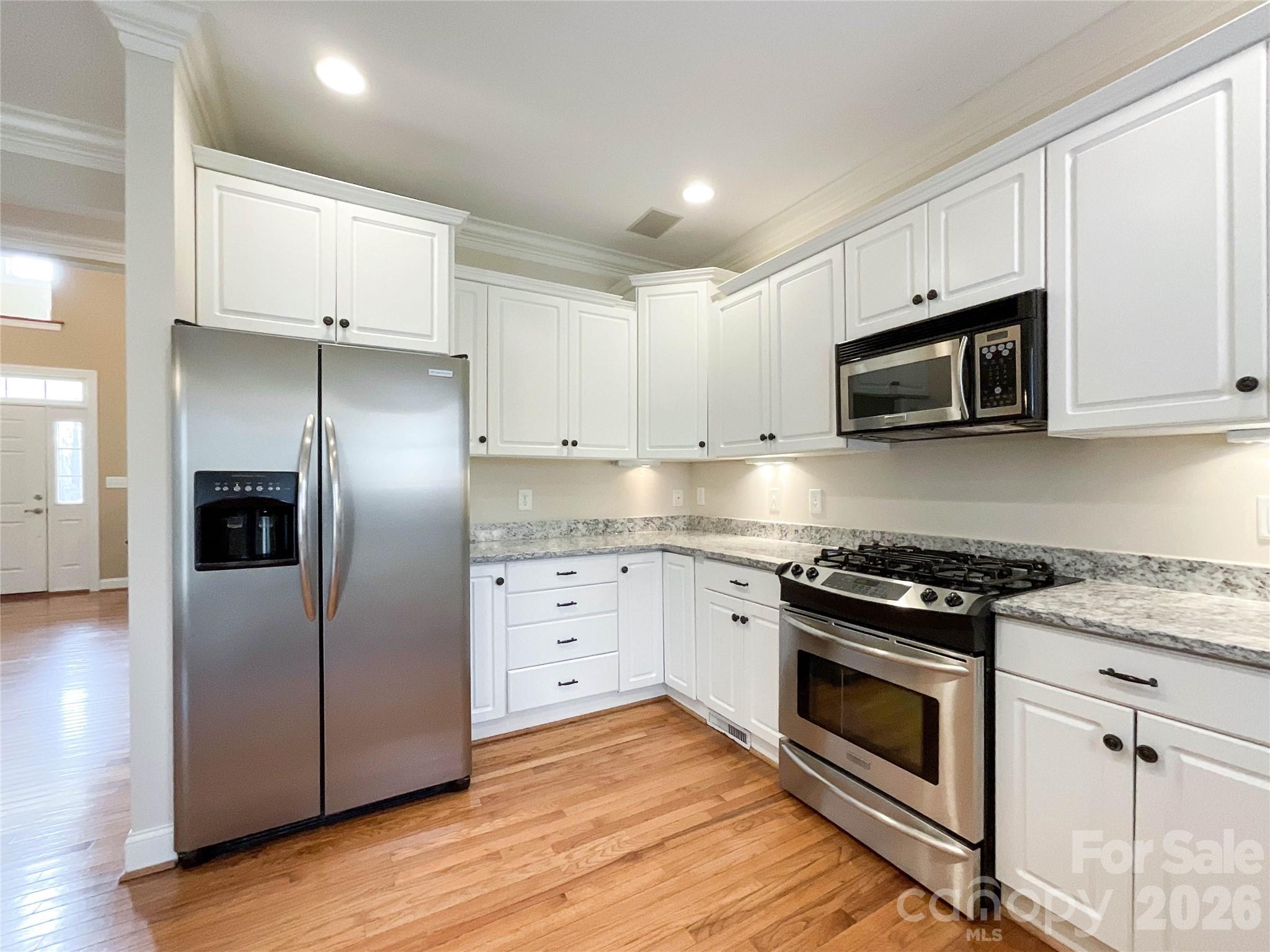 62 Will Evans Road Jefferson, SC 29718 - Photo 12 of 48 a kitchen with cabinets stainless steel appliances and wooden floor