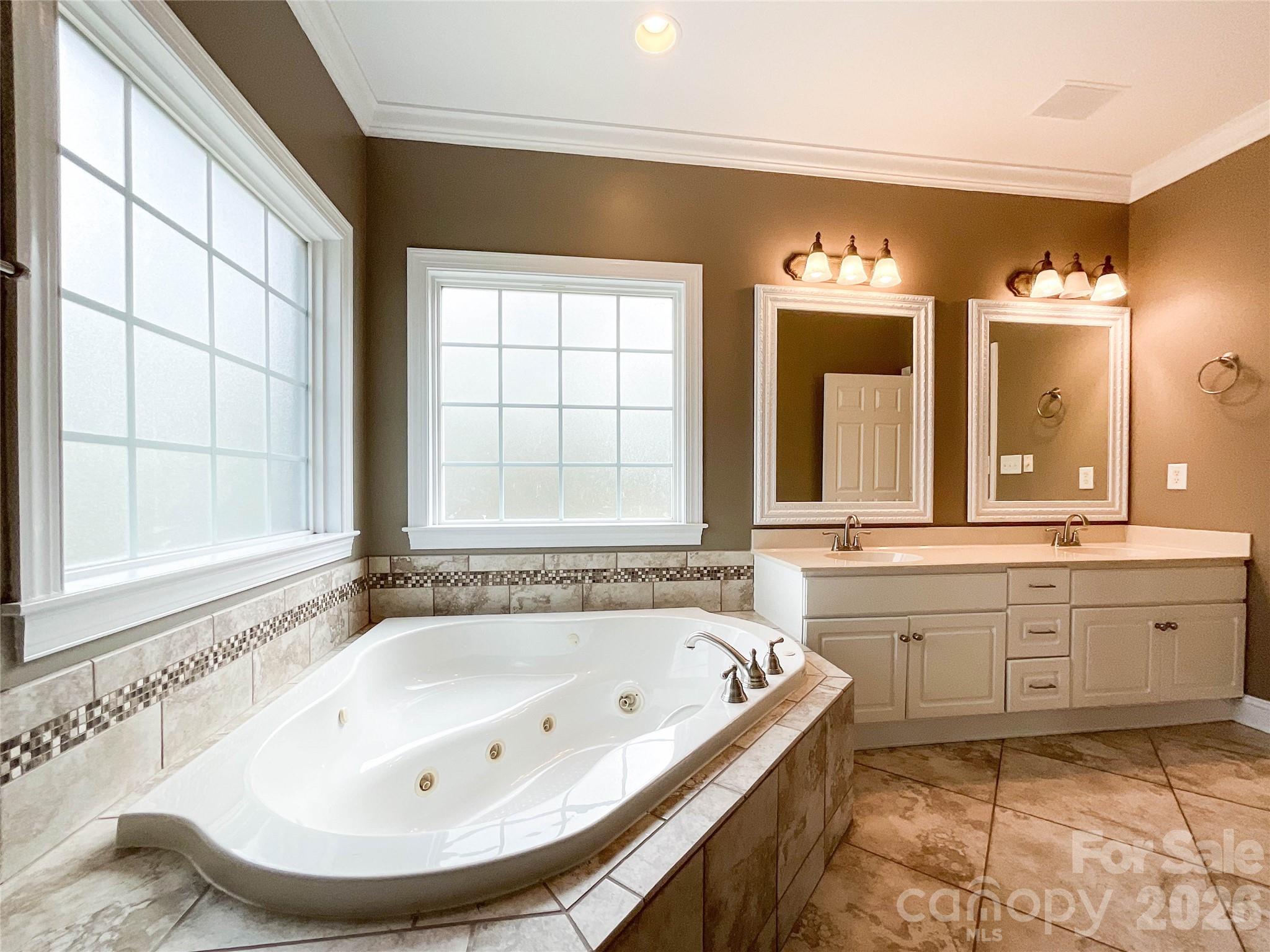 62 Will Evans Road Jefferson, SC 29718 - Photo 24 of 48 a bathroom with a tub sink and mirror