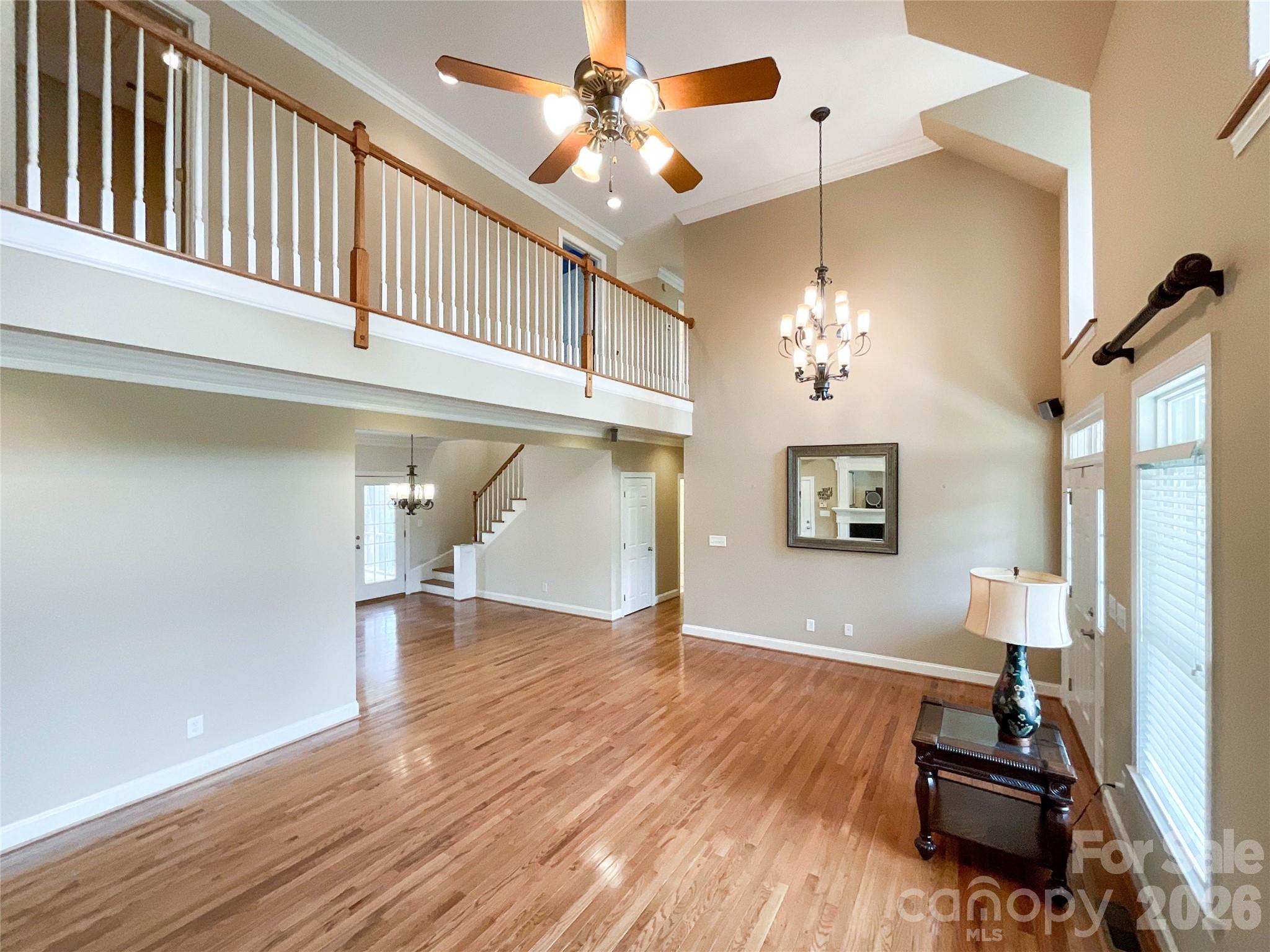 62 Will Evans Road Jefferson, SC 29718 - Photo 7 of 48 a view of a livingroom with wooden floor a ceiling fan and staircase