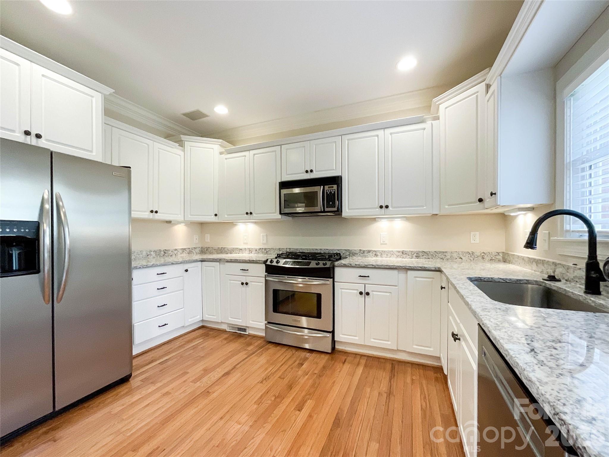 62 Will Evans Road Jefferson, SC 29718 - Photo 10 of 48 a kitchen with granite countertop stainless steel appliances cabinets a sink and a stove