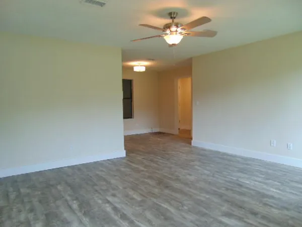 a view of an empty room with a fan