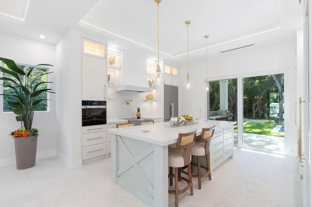 a living room with furniture a chandelier and a dining table