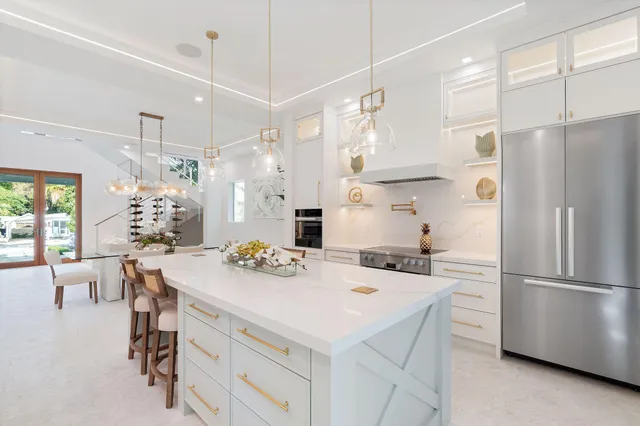 a view of a kitchen with a sink and a refrigerator