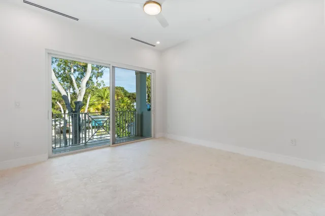 a view of a tennis ground with large trees