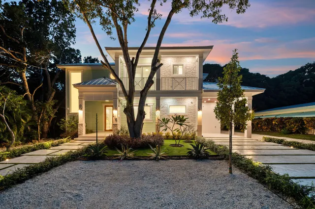 a front view of a house with tree s