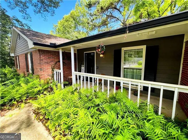 a view of a house with a flower garden