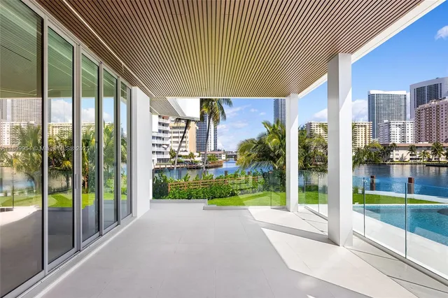a view of a swimming pool with lawn chairs under an umbrella