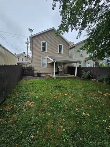 a view of a house with a yard and sitting area