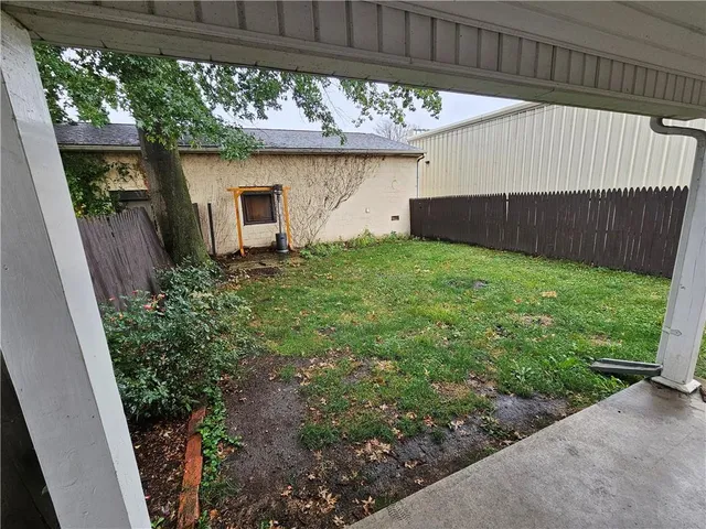 a view of a house with a wooden fence
