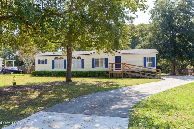 a view of a house with swimming pool and a yard