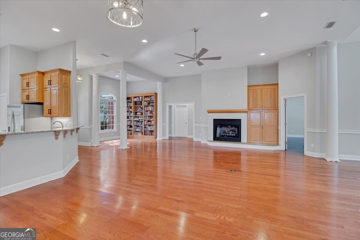 396 Meander Trace Thomasville, GA 31792 - Photo 22 of 50 an empty room with wooden floor and fireplace