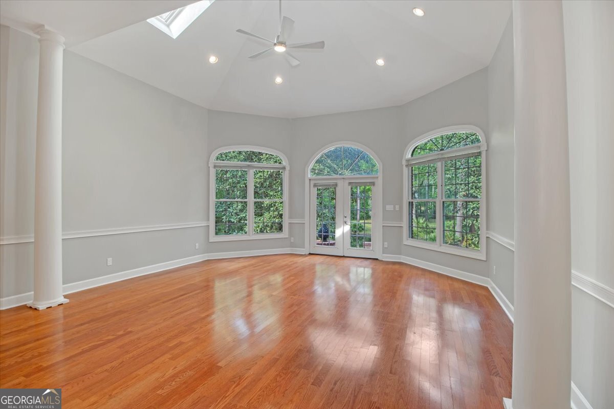 396 Meander Trace Thomasville, GA 31792 - Photo 23 of 50 an empty room with wooden floor and windows