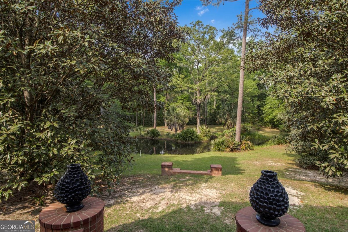 396 Meander Trace Thomasville, GA 31792 - Photo 26 of 50 a view of a garden with a fountain