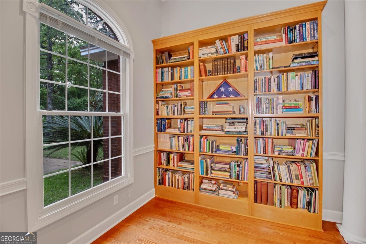 396 Meander Trace Thomasville, GA 31792 - Photo 32 of 50 a view of a book shelf with windows in a room