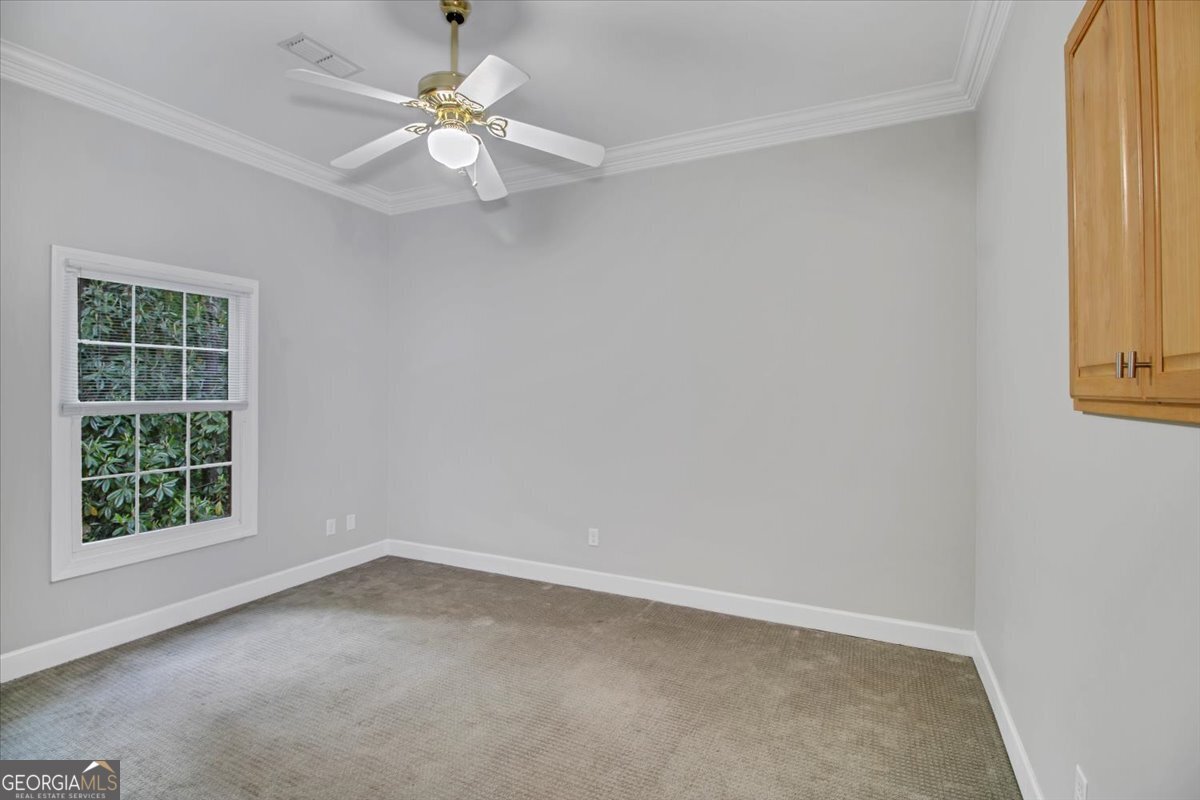 396 Meander Trace Thomasville, GA 31792 - Photo 34 of 50 an empty room with windows and fan