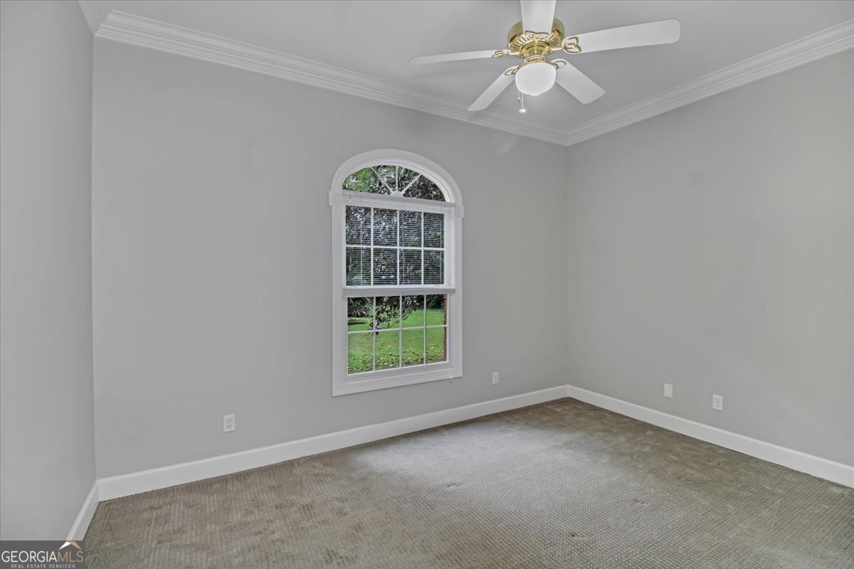 396 Meander Trace Thomasville, GA 31792 - Photo 36 of 50 an empty room with a window and a fan