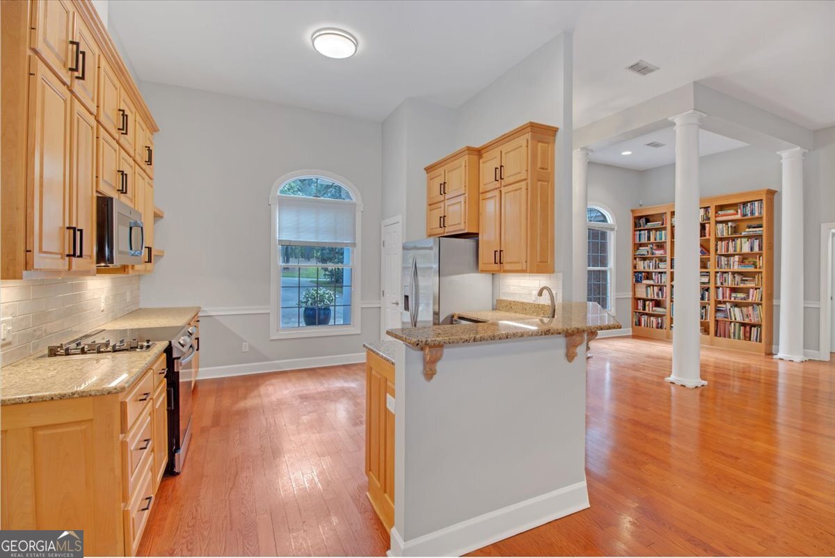 396 Meander Trace Thomasville, GA 31792 - Photo 5 of 50 a living room with stainless steel appliances granite countertop a stove and a wooden floors