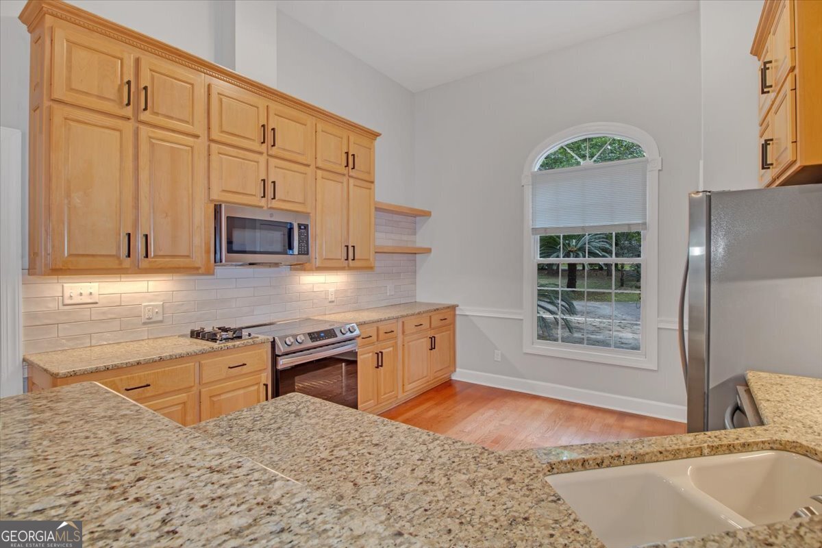 396 Meander Trace Thomasville, GA 31792 - Photo 6 of 50 a kitchen with stainless steel appliances granite countertop a stove a sink and a microwave