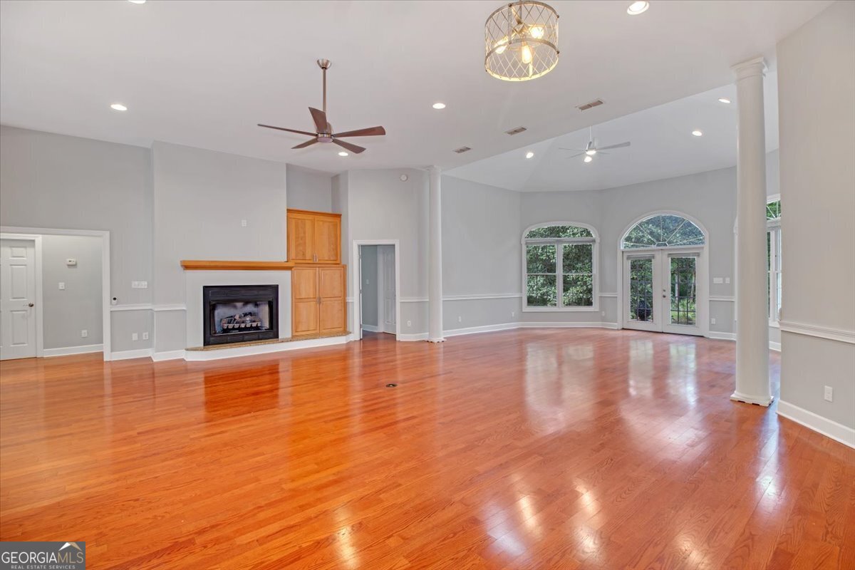 396 Meander Trace Thomasville, GA 31792 - Photo 9 of 50 a view of an empty room with chandelier fan and wooden floor