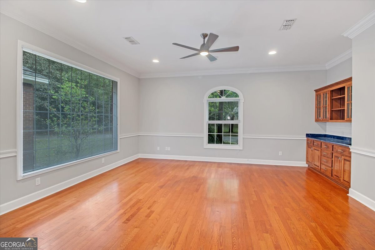 396 Meander Trace Thomasville, GA 31792 - Photo 10 of 50 a view of an empty room with a window and wooden floor