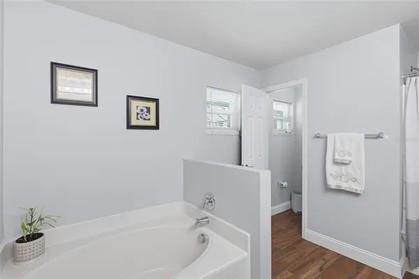 a bathroom with a shower and a tub