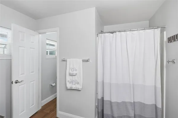 a bathroom with a sink mirror and toilet