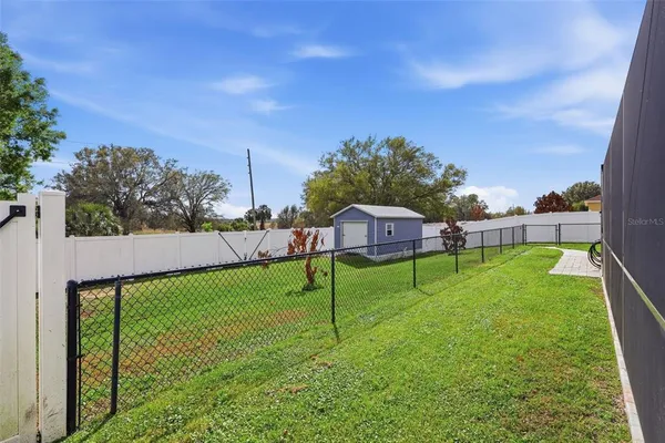 a view of yard with swimming pool and green space