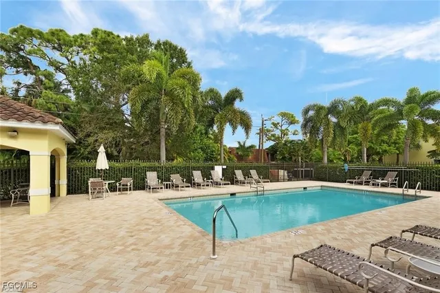 a view of a swimming pool and lounge chairs