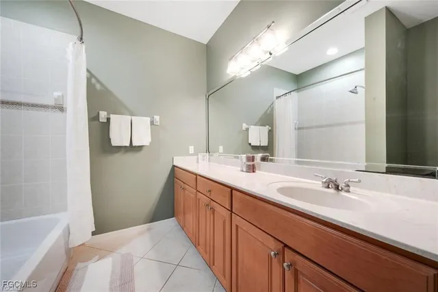 a spacious bathroom with a double vanity sink mirror and a bathtub