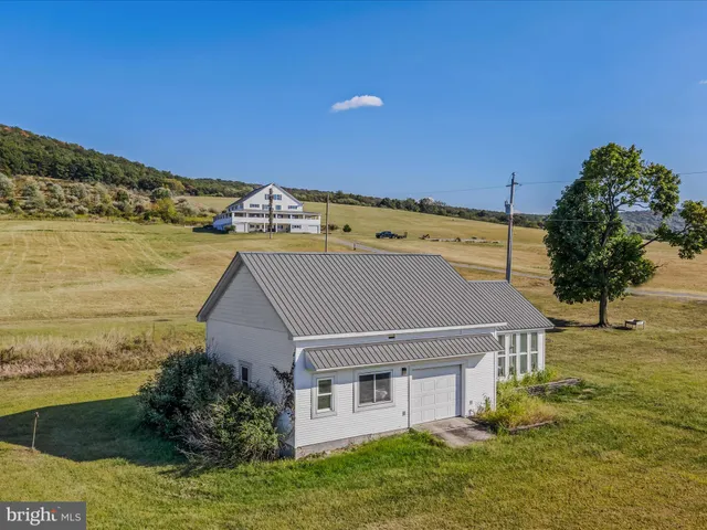 a aerial view of a house with a yard
