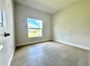 a view of an empty room with a window