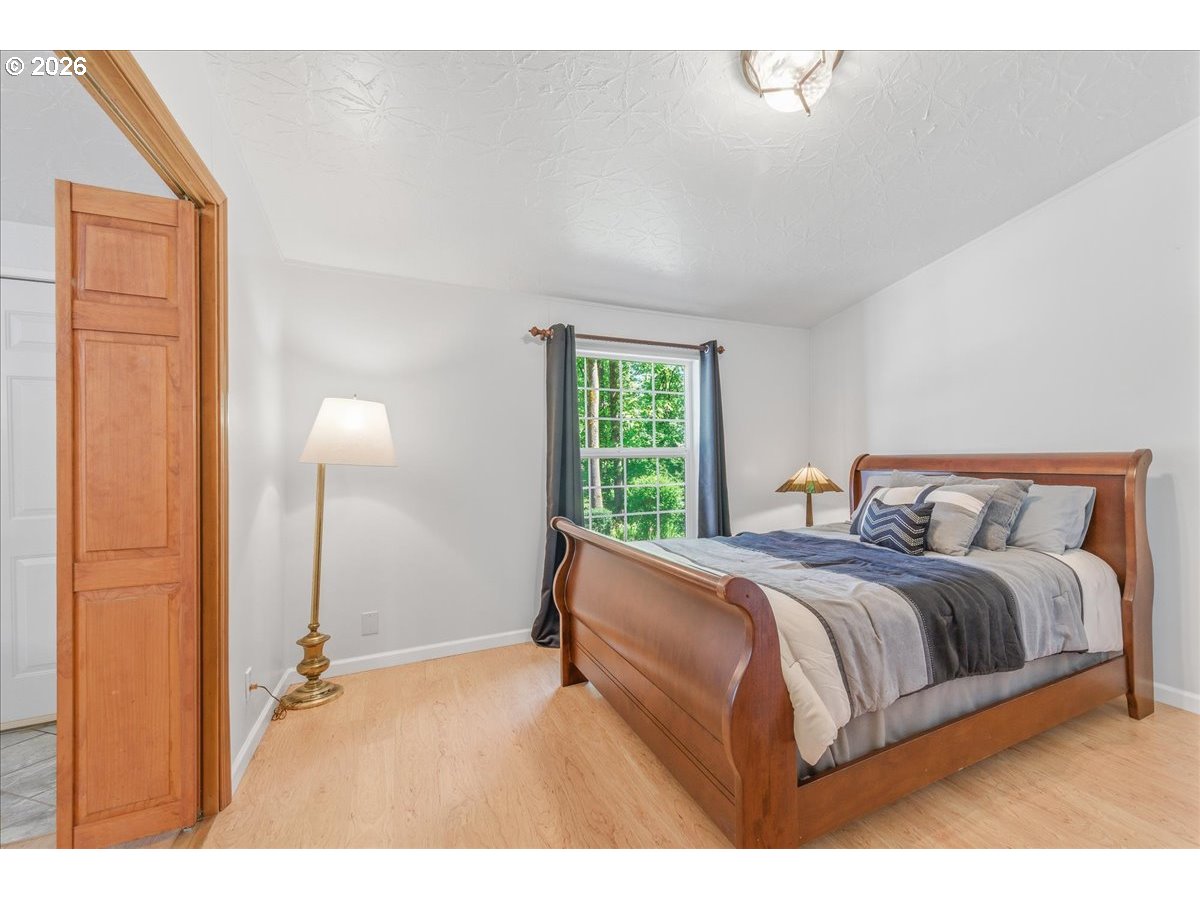 475 East 9th Street Rainier, OR 97048 - Photo 18 of 43 a bedroom with a bed and a window