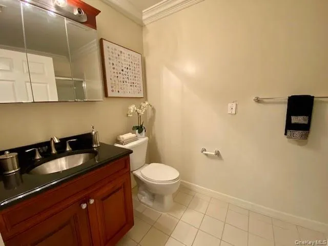 a bathroom with a sink a toilet and mirror