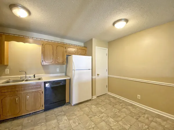 a view of a kitchen with a sink and cabinet