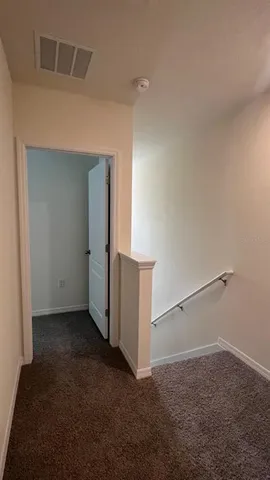 an empty room with windows and entrance