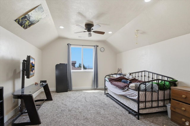 1232 Canyon Road Tooele, UT 84074 - Photo 30 of 54 Spacious room featuring vaulted ceilings, recessed lighting, a ceiling fan, a window with natural light, and grey carpet flooring