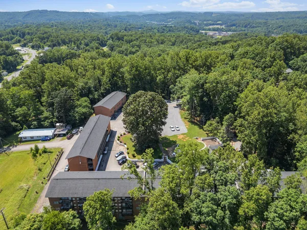 an aerial view of a house with a yard and mountain view